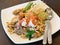 Traditional Thai famous street food, stir fried noodle with sprouts topped with shrimp, call \