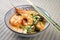 Traditional Thai kaeng phet red curry with king prawns and vegetable in a bowl