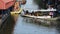 Traditional thai merit offering alms giving to monk procession on boat at Wat Sai Yai in Nonthaburi, Thailand