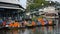 Traditional thai merit offering alms giving to monk procession on boat at Wat Sai Yai in Nonthaburi, Thailand