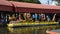 Traditional thai merit offering alms giving to monk procession on boat at Wat Sai Yai in Nonthaburi, Thailand