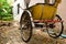 Traditional Thai transport â€“ old yellow trishaw on a street.