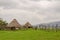 Traditional thatch, clay and wood houses of sheep farmer in highlands of Cameroon, Africa