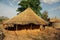 Traditional thatched roof mud building used for storage of onians