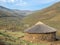 Traditional thatched stone round hut of the Basutho in the mountain highlands of Lesotho, Southern Africa