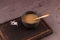 Traditional Tibetan butter tea or churned tea in dark bowl on cutting board.  Asian drink known as