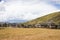 Traditional Tibetan countryside with fields, mountains and blue sky around around Daocheng