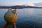 Traditional Totora Reed Boat with Puma Head Prow against Lake Titicaca at Sunset, Puno, Peru