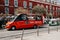 A traditional tourist minibus rides a city street in Lisbon