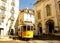 A traditional tram `elÃ©ctrico` from Lisbon down Rua da Madalena and passing in front of the Church of Madalena