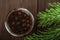 Traditional Trend Siberian dessert - young pine cones jam. Ukrainian cone jam in a jar on a dark background close-up and copy spac