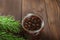 Traditional Trend Siberian dessert - young pine cones jam. Ukrainian cone jam in a jar on a dark background close-up and copy spac