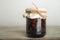 Traditional Trend Siberian dessert - young pine cones jam. Ukrainian cone jam in a jar on a light background close-up and copy spa