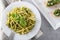 Traditional trofie pasta with pesto sauce on white plate