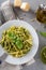 Traditional trofie pasta with pesto sauce on white plate