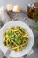 Traditional trofie pasta with pesto sauce on white plate