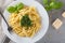 Traditional trofie pasta with pesto sauce on white plate