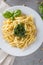 Traditional trofie pasta with pesto sauce on white plate