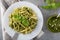 Traditional trofie pasta with pesto sauce on white plate