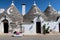 The traditional Trulli houses in the street of Alberobello city, Italy, Apulia region with typical souvenir shop