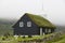 Traditional turf church in Faroe islands foggy day. Kaldbak