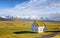 Traditional turf covered house in Glaumbaer, northwestern Iceland. Agricultural fields with horses, and snow-covered mountains in