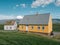 Traditional turf covered house in Glaumbaer, northwestern Iceland. Agricultural fields with horses, and snow-covered mountains in