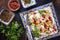 Traditional Turk manti steamed with mincemeat and paprika tomato salad on a plate