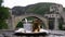 Traditional Turkish coffee and a view of Mostar Old bridge and river Neretva. Bosnian coffee in a cezve with a turkish delight