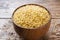 Traditional Turkish dry raw bulgur cereal in a wooden bowl