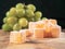 Traditional Turkish and Greek rose flavor jelly candy in sugar powder and green grapes on a wooden board and black background.