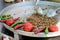 Traditional Turkish shaorma meat being prepared with red tomatoes and red and green peppers, available for sale at a street food m