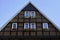Traditional typical old house construction. Historic half timbered wooden german house facade