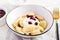 Traditional ukrainian / russian cottage cheese lazy dumplings served with sour cream and cherry jam