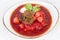 Traditional Ukrainian and Russian soup borscht with beef and beetroot on a white background.