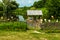 Traditional ukrainian village landscape with wooden fence, clay pitchers hanging on it