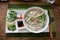 Traditional Vietnamese chicken soup pho on a wooden background.