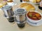 Traditional Vietnamese coffee Phin stainless steel filter, chicken curry and loaves of baguette bread for breakfast