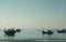 Traditional Vietnamese fishing boats moored at a beach.