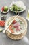 Traditional Vietnamese soup Pho bo with herbs, meat, rice noodles, broth. Pho bo in bowl with chopsticks, spoon. Space for text.