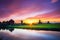 Traditional village with dutch windmills and river at sunset, Holland, Netherlands.