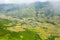 The traditional village on the mountainsides with tropical forests with green and yellow rice terraces, in Asia, Vietnam, Tonkin,