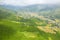 The traditional village on the mountainsides with tropical forests with green and yellow rice terraces, in Asia, Vietnam, Tonkin,