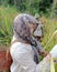 traditional way of harvesting rice in West Kalimantan Indonesia. Young woman. Agriculture.