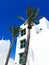 Traditional white architecture and standing next to palm trees against the beautiful blue sky in Nahariya, Israel