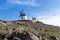 Traditional whitewashed Spanish windmills in La Mancha on a hilltop above Consuegra