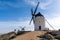 Traditional whitewashed Spanish windmills in La Mancha on a hilltop above Consuegra