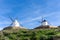 Traditional whitewashed Spanish windmills in La Mancha on a hilltop above Consuegra