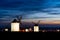 Traditional whitewshed Spanish windmills in La Mancha just after sunset under a cool blue night sky