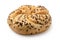 Traditional whole wheat kaiser roll with linseeds and sesame seeds isolated on white